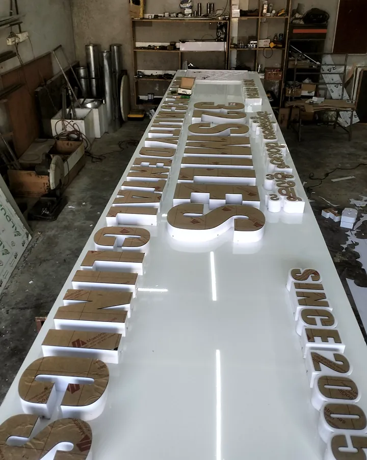 Long 32 Smiles board with 3D letters laid out on the workshop bench