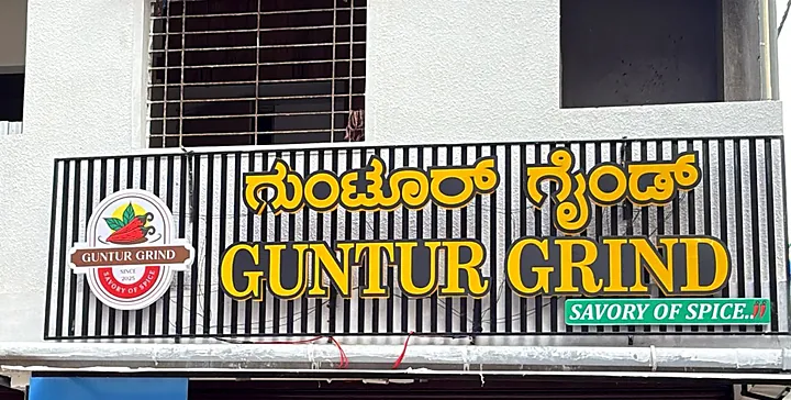 Guntur Grind fascia by day: gold letters on black slats